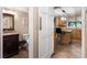 Clean bathroom with granite countertop and a view into the kitchen at 6006 Soaring Ave, Temple Terrace, FL 33617