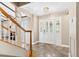 Bright entry hall with staircase and tile floors at 6006 Soaring Ave, Temple Terrace, FL 33617