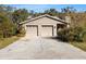House exterior with two-car garage and driveway at 6006 Soaring Ave, Temple Terrace, FL 33617