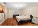 Main bedroom with hardwood floors, large bed, and window at 6006 Soaring Ave, Temple Terrace, FL 33617