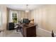 Home office with large desk and window at 6006 Soaring Ave, Temple Terrace, FL 33617