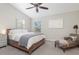 Spacious main bedroom with wood bed frame and ceiling fan at 601 Vallance Ne Way, St Petersburg, FL 33716