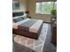 Well-lit bedroom with a large window and a view of trees, offering a serene and comfortable space at 6232 Bayside Key Dr, Tampa, FL 33615