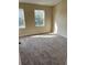 Bright bedroom with dual windows and plush carpeting, offering a cozy and naturally lit space at 6232 Bayside Key Dr, Tampa, FL 33615