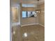 A dining room featuring tile floors, a modern chandelier, and an adjacent kitchen area at 6232 Bayside Key Dr, Tampa, FL 33615