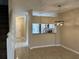 A dining room featuring tile floors, a modern chandelier, and an adjacent kitchen area at 6232 Bayside Key Dr, Tampa, FL 33615