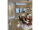 A dining room featuring tile floors, a modern chandelier, and an adjacent kitchen area at 6232 Bayside Key Dr, Tampa, FL 33615