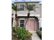 Inviting exterior of townhome with pink door and landscaping at 6232 Bayside Key Dr, Tampa, FL 33615