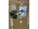 Inviting living room with a comfortable green sofa, chairs, and sliding glass doors at 6232 Bayside Key Dr, Tampa, FL 33615