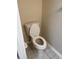 A toilet in a small half bathroom with tiled floors and painted walls at 6232 Bayside Key Dr, Tampa, FL 33615