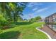 Landscaped backyard with a view of neighboring homes and a flag at 10328 Henderson St, Spring Hill, FL 34608