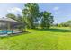 Spacious backyard with lush green grass and mature trees, providing ample space at 10328 Henderson St, Spring Hill, FL 34608