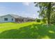 Large backyard with home view, providing a green space and privacy at 10328 Henderson St, Spring Hill, FL 34608