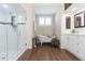Elegant bathroom with soaking tub, walk-in shower, and modern vanity at 10328 Henderson St, Spring Hill, FL 34608
