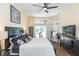 Spacious bedroom with large windows, pool view, and ceiling fan at 10328 Henderson St, Spring Hill, FL 34608