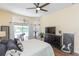 Bright bedroom featuring a king-size bed and access to backyard at 10328 Henderson St, Spring Hill, FL 34608