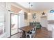 Kitchen dining area features a rustic wooden table and white metal chairs at 10328 Henderson St, Spring Hill, FL 34608