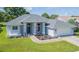 Single-story house with gray exterior, two car garage, and landscaped yard at 10328 Henderson St, Spring Hill, FL 34608