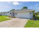 Single-story home with gray exterior, two-car garage, and landscaped yard at 10328 Henderson St, Spring Hill, FL 34608