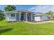 Single story home with gray exterior, two-car garage, and landscaped yard at 10328 Henderson St, Spring Hill, FL 34608