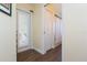 Home hallway featuring wood-look floors, a door to an exterior area, and access to a bathroom at 10328 Henderson St, Spring Hill, FL 34608