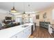 Open concept kitchen with white cabinets, island, and view of living room at 10328 Henderson St, Spring Hill, FL 34608