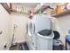 Laundry room with washer, dryer, and ample storage shelving at 10328 Henderson St, Spring Hill, FL 34608