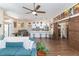 Open living room features a teal sofa, barn door, and hardwood floors at 10328 Henderson St, Spring Hill, FL 34608