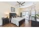 Main bedroom with a king-size bed, nightstands, and access to a patio at 10328 Henderson St, Spring Hill, FL 34608