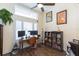 Home office with built-in bookshelves and hardwood floors at 10328 Henderson St, Spring Hill, FL 34608
