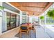 Relaxing covered patio with outdoor furniture and a ceiling fan at 10328 Henderson St, Spring Hill, FL 34608