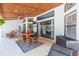 Covered patio with wooden dining table and chairs, ideal for outdoor dining at 10328 Henderson St, Spring Hill, FL 34608