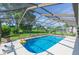 Inviting screened pool area with lounge chairs and lush landscaping at 10328 Henderson St, Spring Hill, FL 34608
