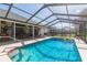 Inviting screened pool area with patio furniture, offering a relaxing outdoor space at 10328 Henderson St, Spring Hill, FL 34608