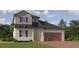 Two story home with dark brown garage door and solar panels at 11854 Sparkling Topaz Cv, Parrish, FL 34219
