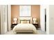 Bedroom with light beige walls and bedding, and two nightstands at 11869 Sparkling Topaz Cv, Parrish, FL 34219