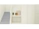 Modern staircase with grey carpeting and a built-in storage niche at 11869 Sparkling Topaz Cv, Parrish, FL 34219