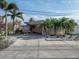 Mid-century modern home with carport and palm trees at 16124 4Th E St, Redington Beach, FL 33708