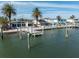 Backyard oasis showcasing waterfront access and palm trees at 16124 4Th E St, Redington Beach, FL 33708
