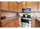 Stainless steel appliances and light wood cabinets in this corner kitchen at 216 S Westland Ave # 4, Tampa, FL 33606