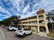Two-story condo building with parking and mature trees at 2226 Switzerland Way # 30, Clearwater, FL 33763