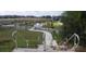 New community with pond, road, and homes under construction at 36141 Welsh Glade Rd, Dade City, FL 33525