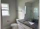 Clean bathroom with granite countertop, white cabinets, and a large mirror at 36159 Welsh Glade Rd, Dade City, FL 33525