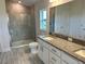 Main bathroom with granite vanity, large shower and tile flooring at 36159 Welsh Glade Rd, Dade City, FL 33525