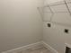 Bright laundry room with wire shelving and space for washer and dryer at 36159 Welsh Glade Rd, Dade City, FL 33525