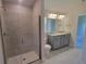Modern bathroom with walk-in shower and double vanity at 36179 Welsh Glade Rd, Dade City, FL 33525