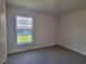 Well-lit bedroom with carpet and a window view at 36179 Welsh Glade Rd, Dade City, FL 33525