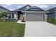 Curb appeal abounds in this charming new construction home, featuring a two-car garage and tasteful landscaping at 36179 Welsh Glade Rd, Dade City, FL 33525