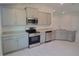 Modern kitchen featuring gray cabinets, stainless steel appliances, and granite countertops at 36179 Welsh Glade Rd, Dade City, FL 33525