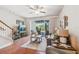 Bright living room with hardwood floors, sliding glass doors, and comfortable seating at 521 Harbor Ridge Dr, Palm Harbor, FL 34683
